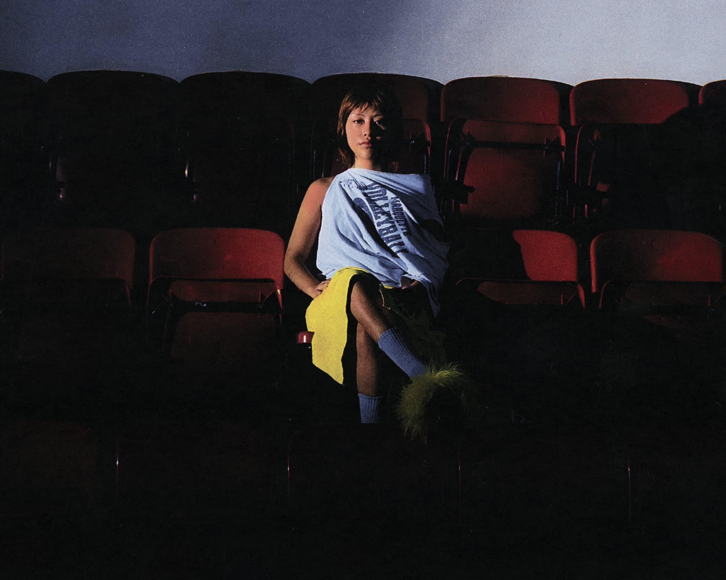 Gina Corrieri SS24 editorial, cinema seats, seated. Photo by George William Vicary.