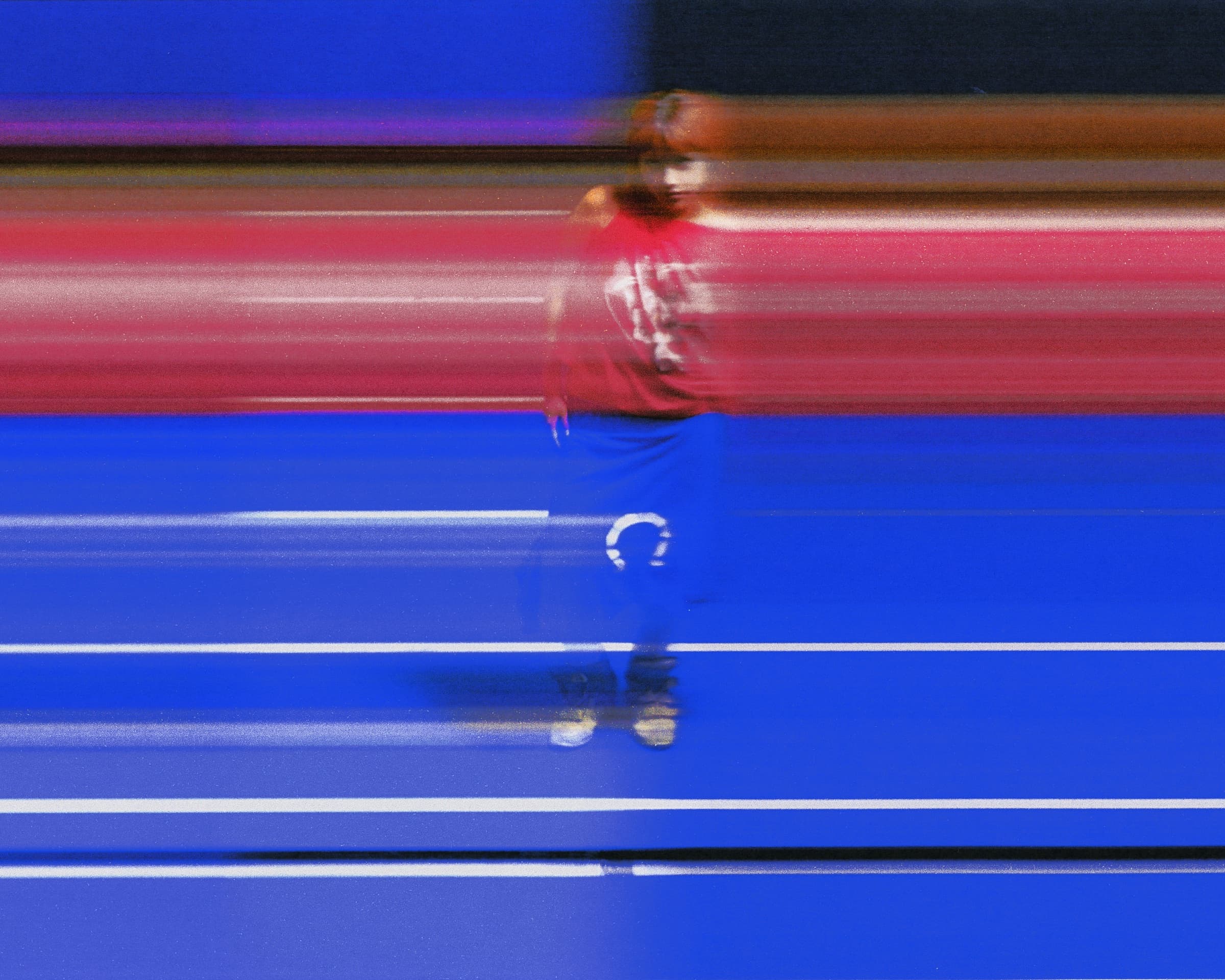 Gina Corrieri SS24 editorial, blue track, motion-blur walk. Photo by George William Vicary.