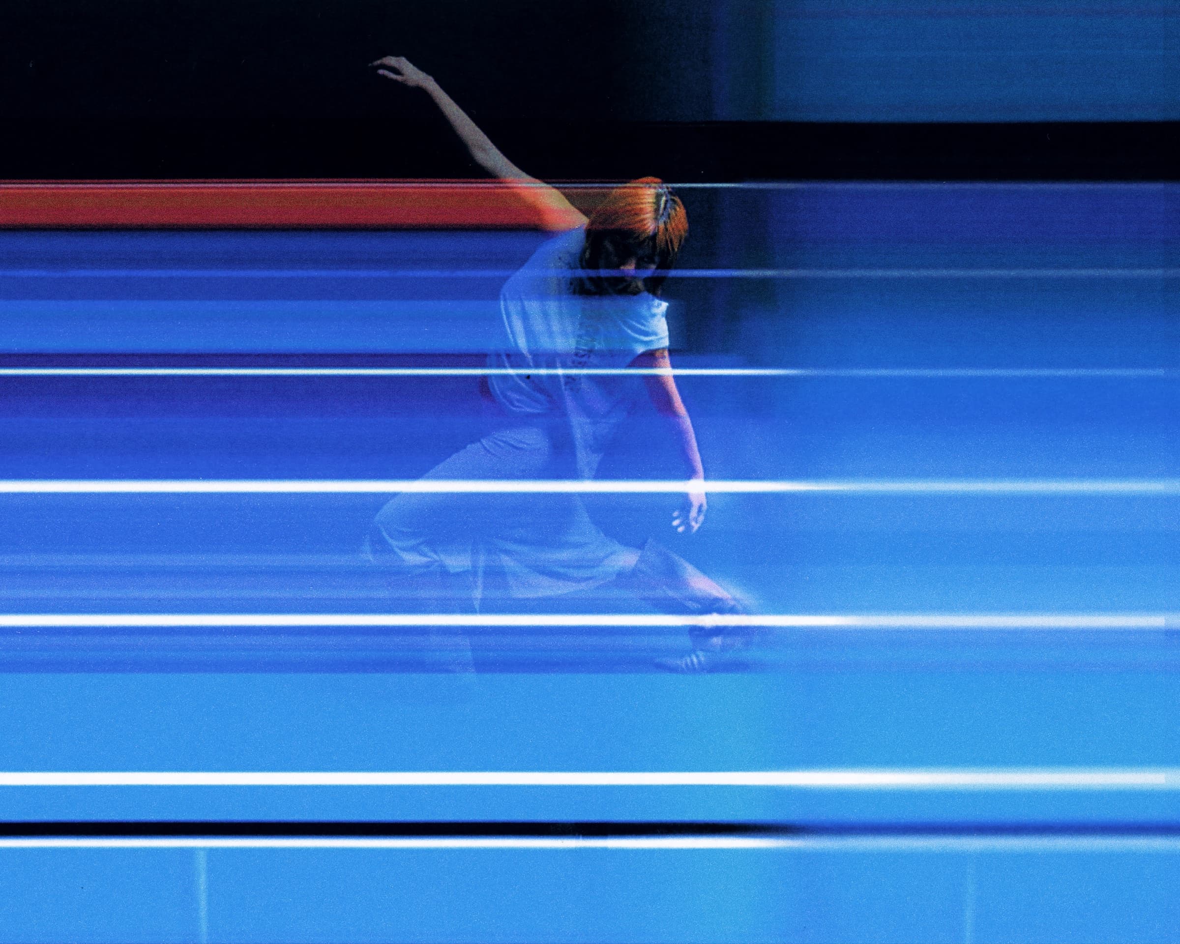 Gina Corrieri SS24 editorial, blue track, arm-raised motion-blur. Photo by George William Vicary.