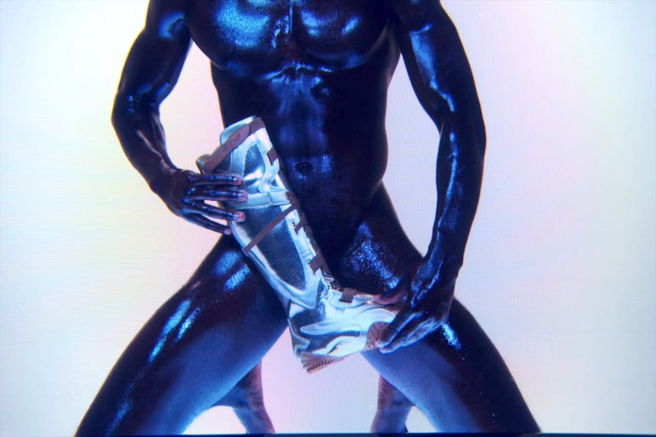 Ottolinger x Puma still, a chrome figure holding the translucent Ottolinger bag against an iridescent backdrop.